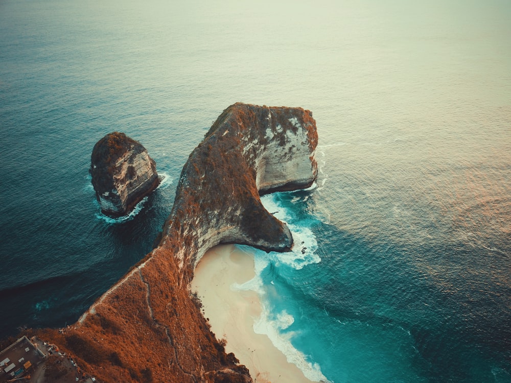 aerial photography of a mountain cliff by the beach