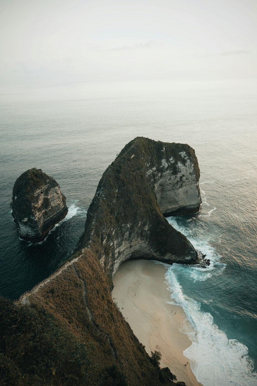 wide-angle photography of mountain beside seashore during daytime