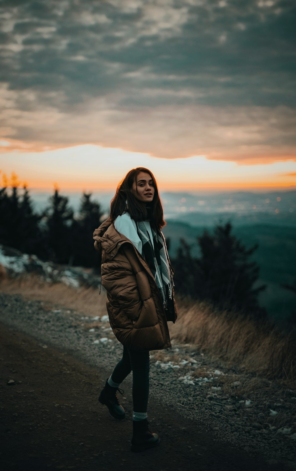 woman walking along a road during golden hour