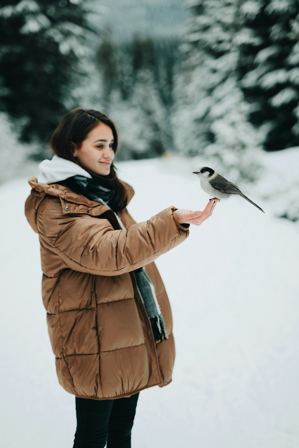 woman holding black and white bird