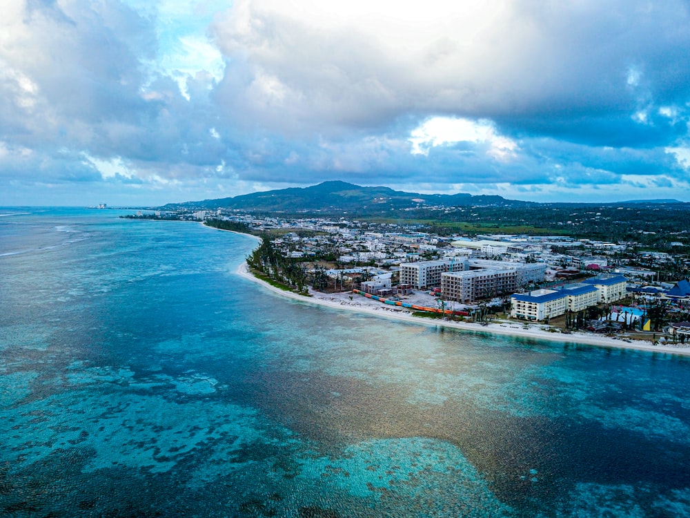 wide-angle photography of buildings beside seashore during daytime