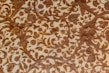 Intricate patterns of floral and foliage designs are carved elegantly into a surface, with detailed depictions of leaves, flowers, and fruits intertwined across the textured background. The craftsmanship reflects a harmonious blend of natural elements creating a vintage or classical aesthetic.
