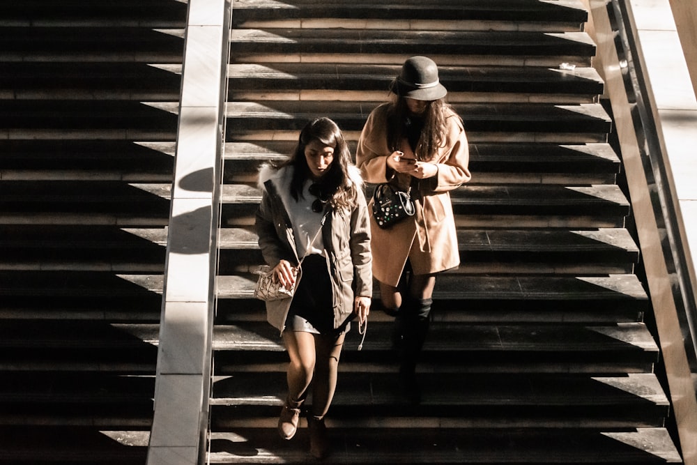 two women walking down stairs