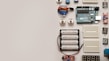 A collection of electronic components including an Arduino board, breadboards, batteries, potentiometers, and various sensors arranged neatly on a flat surface.