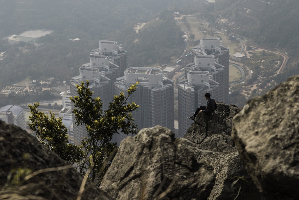 man sitting on cliff