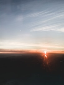 A cinematic shot of a sunrise breaking through clouds symbolizing new beginnings and transformation.