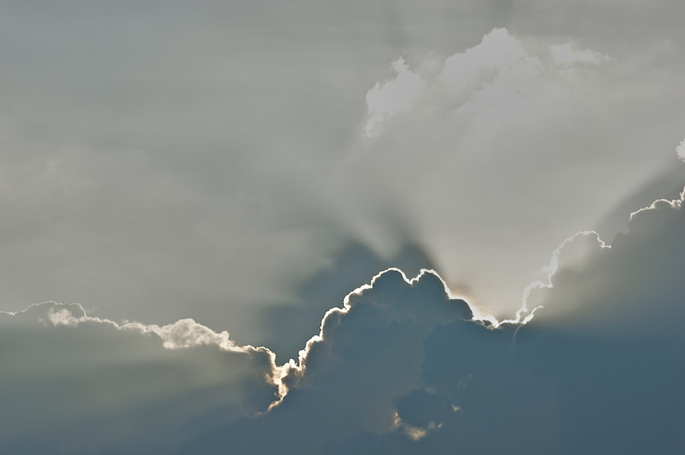 a plane flying in the sky with a lot of clouds