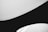 Curved black and white surfaces create a minimalist and abstract composition with clean lines and smooth contrasts.