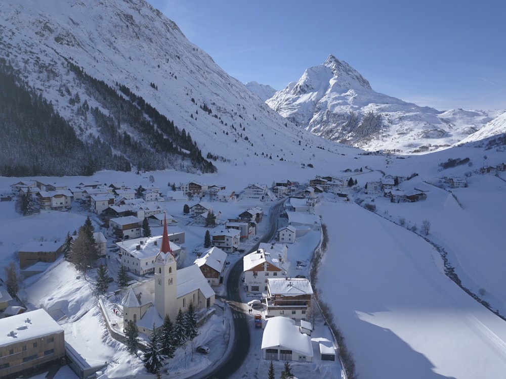 aerial view of snow covered houses near rock formation