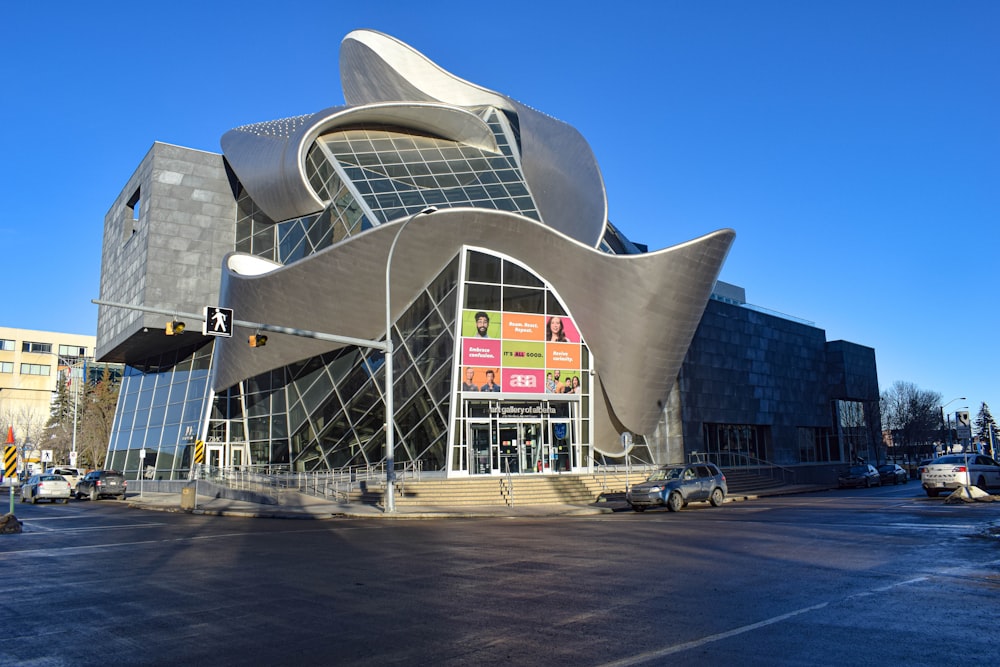 a large building with a curved roof on a street corner