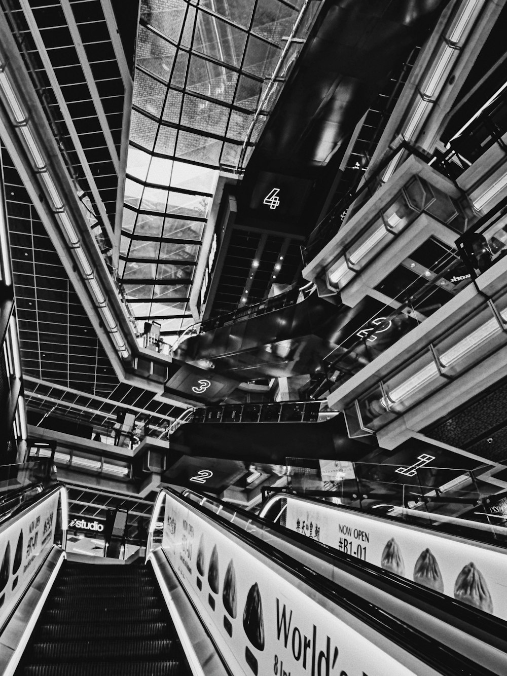 a black and white photo of an escalator