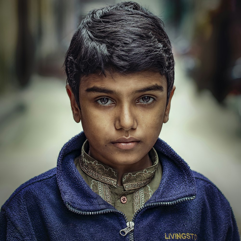 boy in blue zip-up jacket