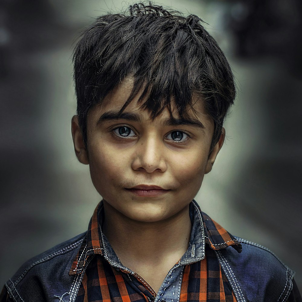 boy in blue and orange collared top