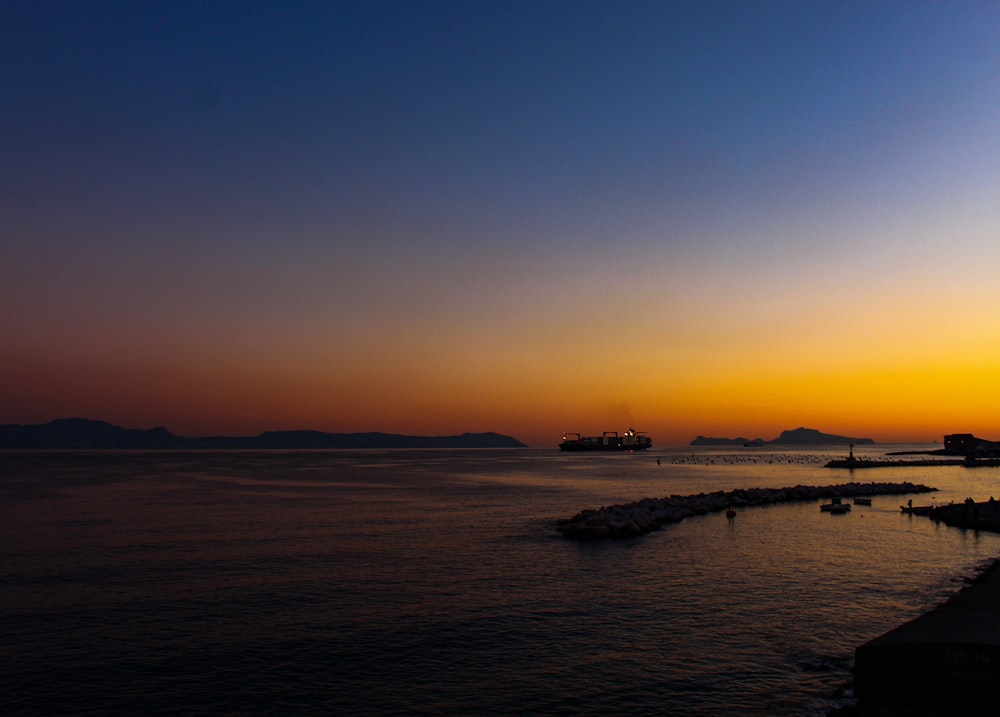 calm body of water during golden hour