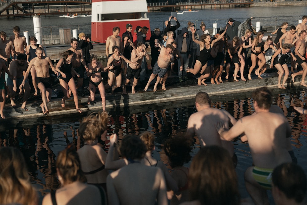 group of people about to jump on body of water