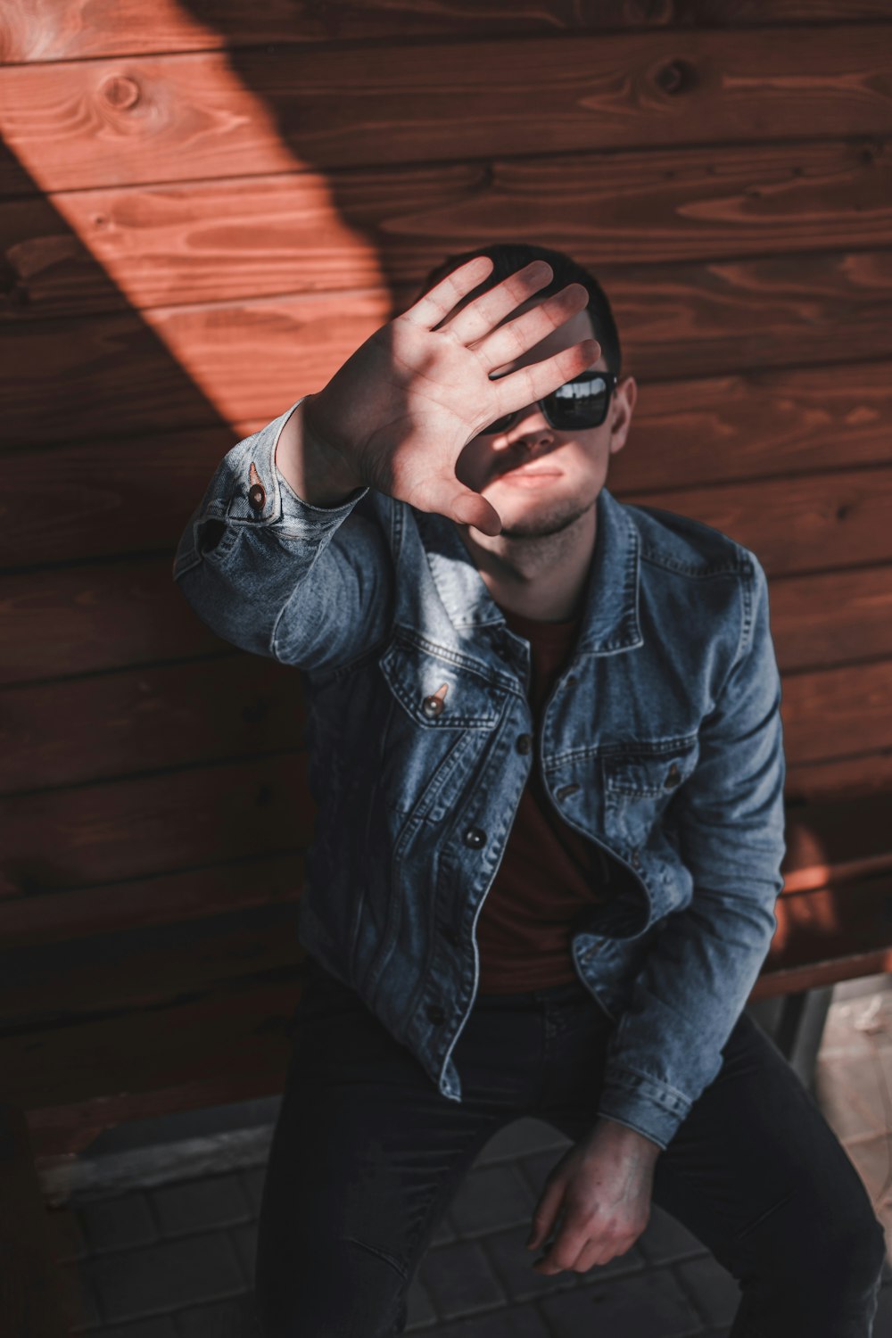 sitting man showing his right palm