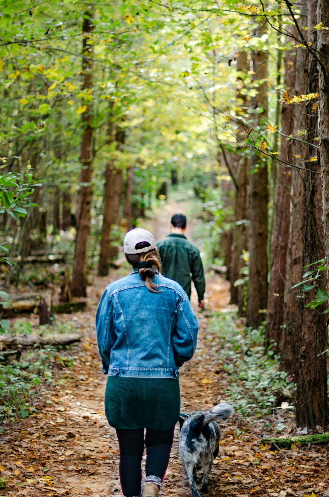 man and woman walking on trail
