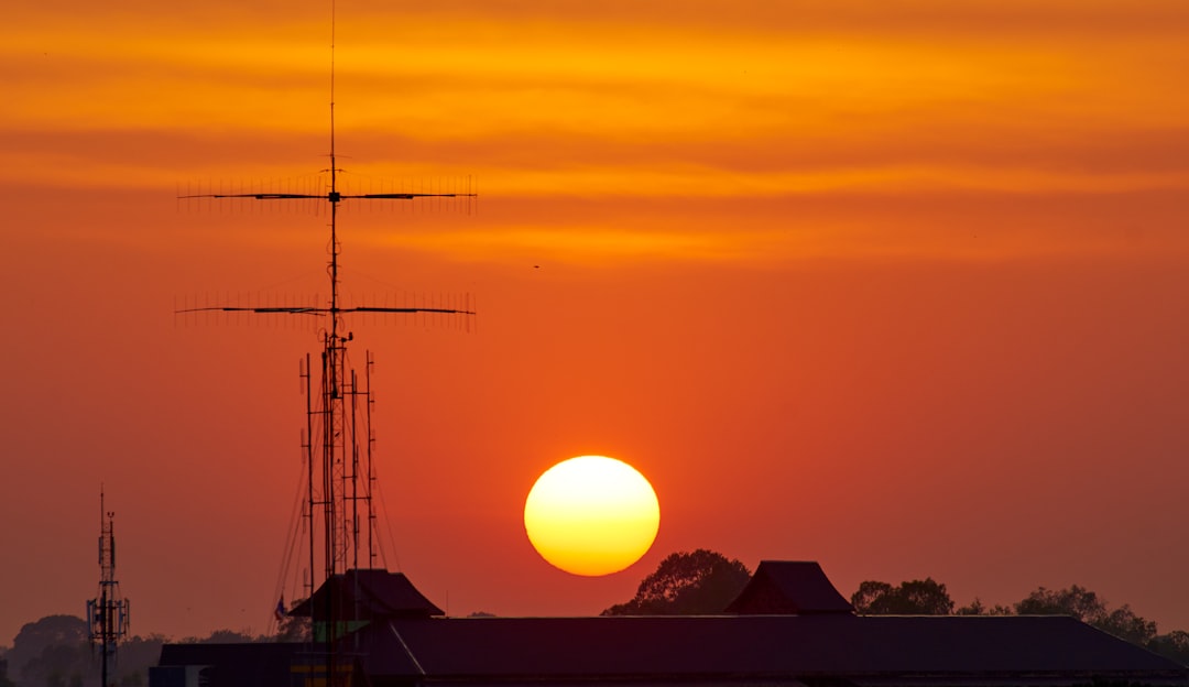 house beside utility pole during golden hour