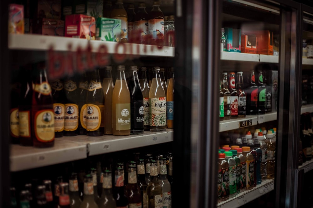 assorted flavor of wines and liquors on display in cabinet