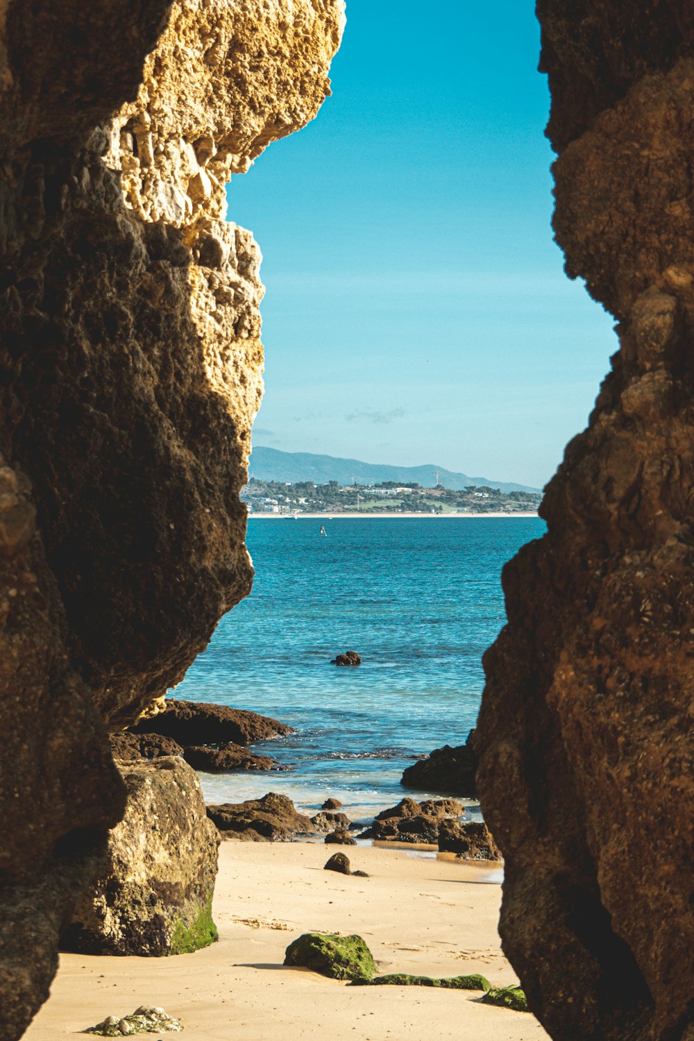 a view of the ocean through a rock arch