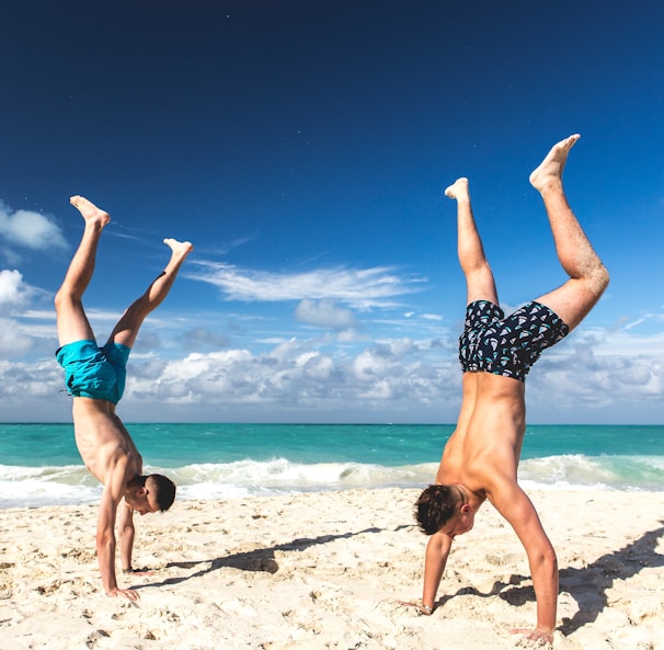 two people hand standing on sand