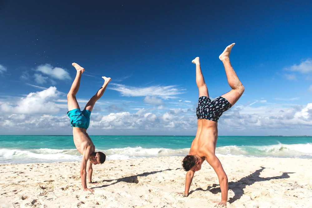 two people hand standing on sand