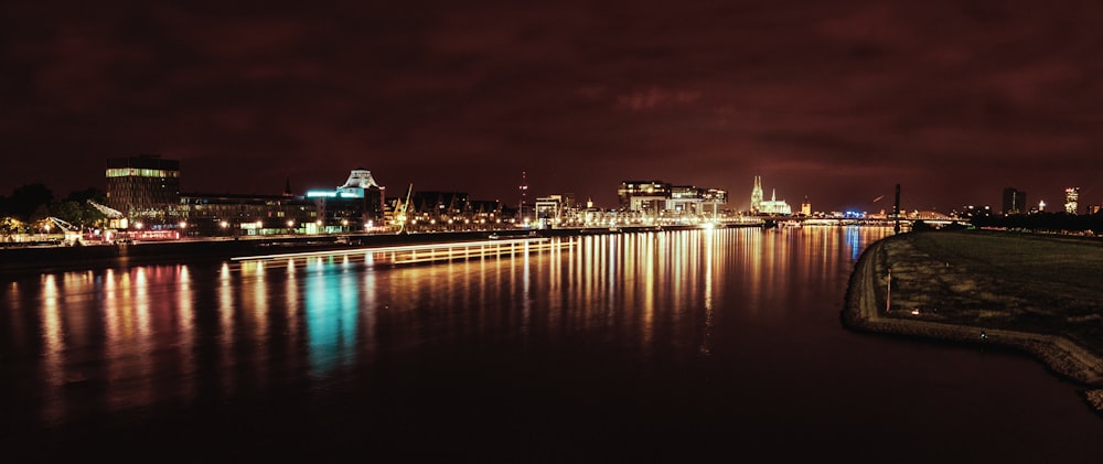 reflection of city lights on body of water at night