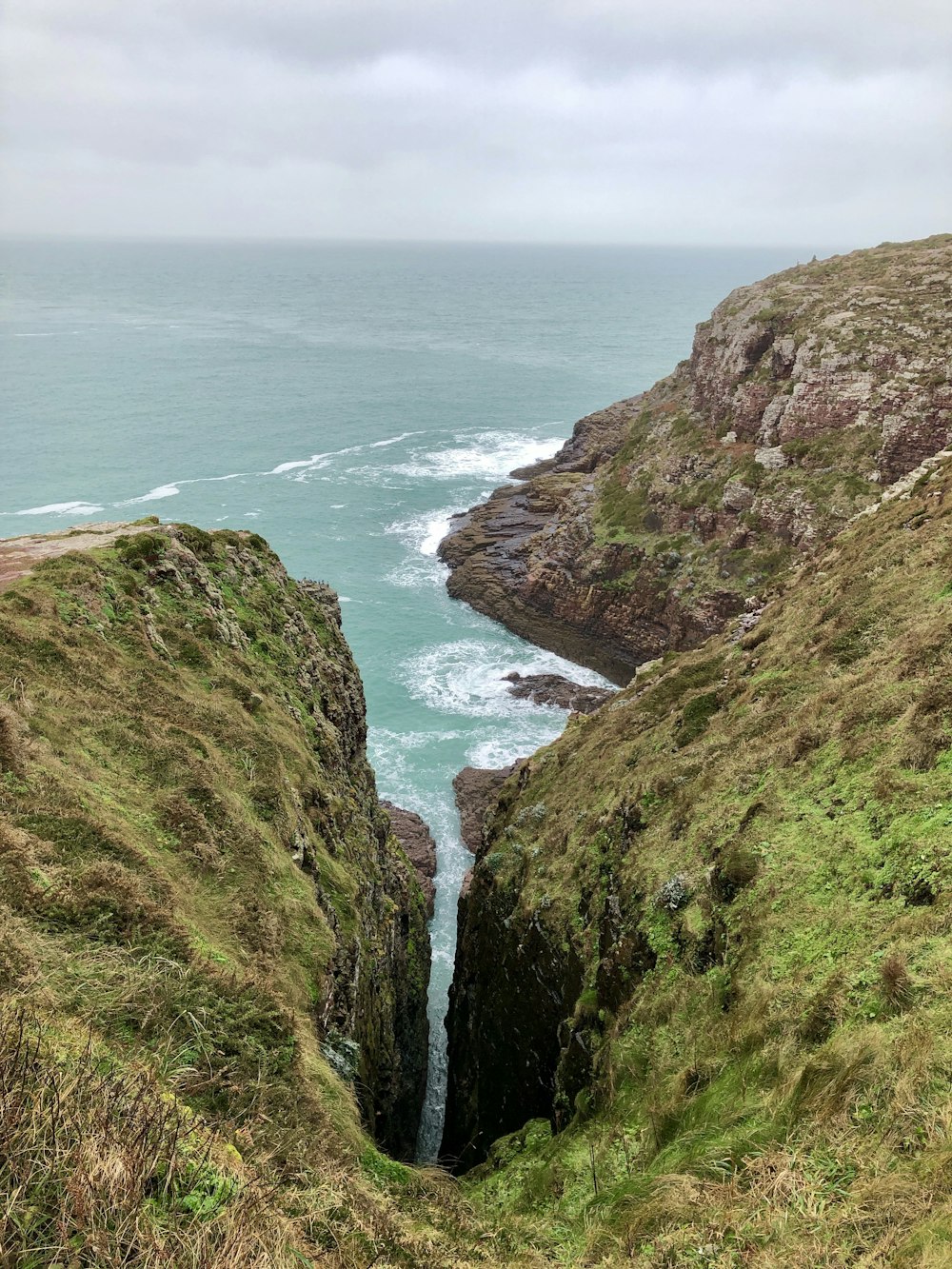 green sea cliff during daytime