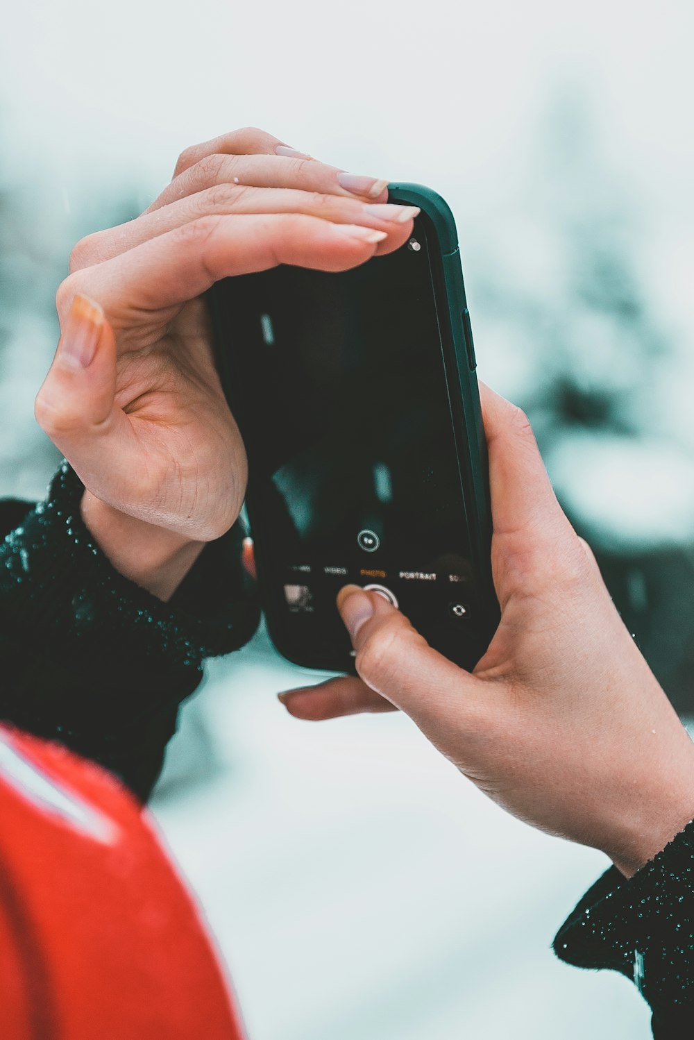selective focus photography of person holding black smartphone
