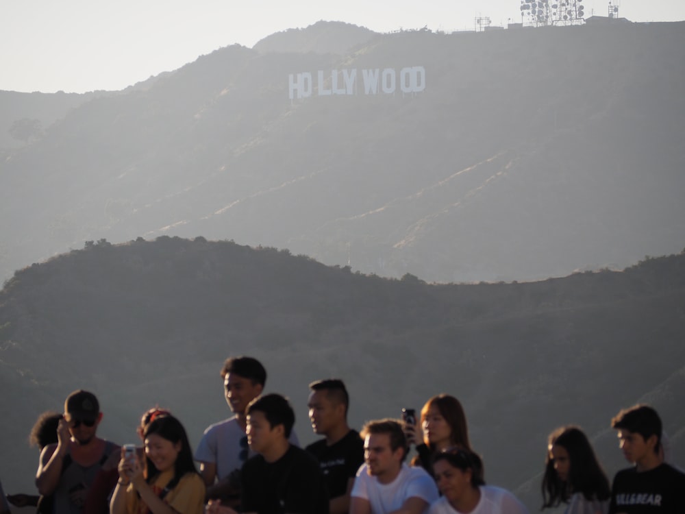 people holding smartphones near Hollywood sign