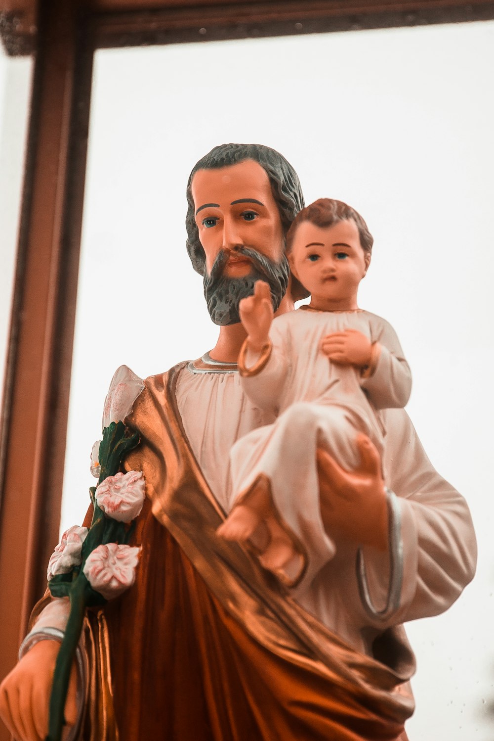 selective focus photography of father and son figurine