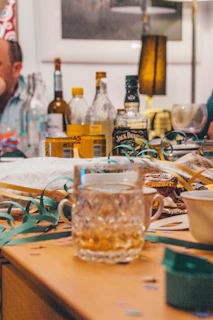 drinking glasses and wine bottles on wooden surface