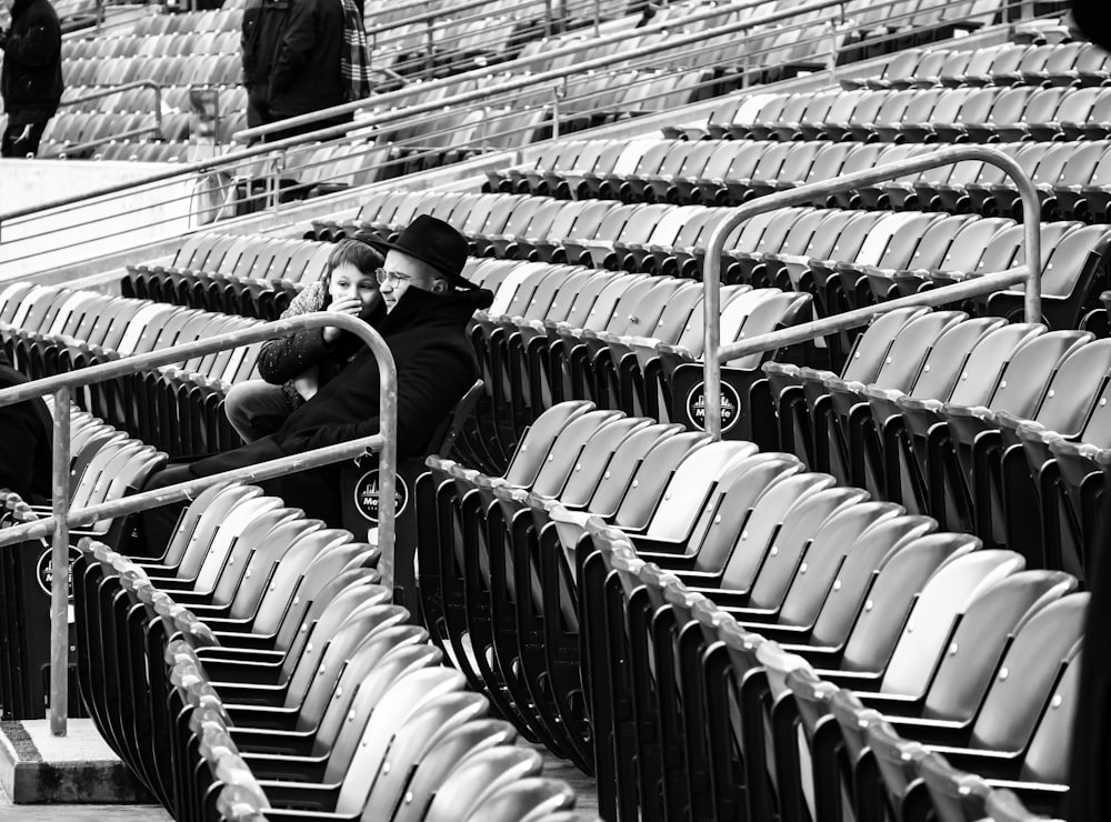 a woman sitting in a row of empty seats