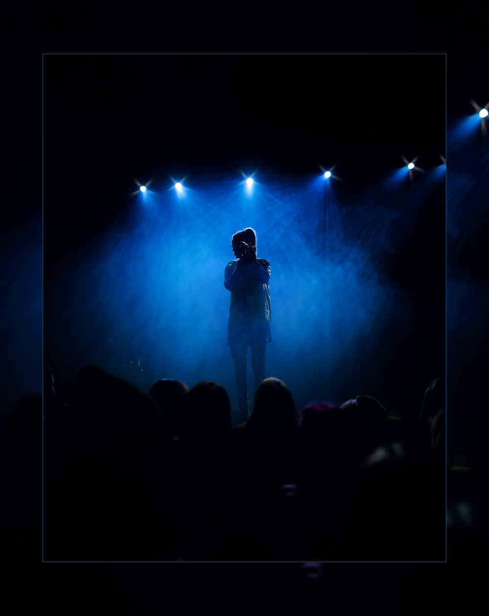 silhouette of standing person on stage
