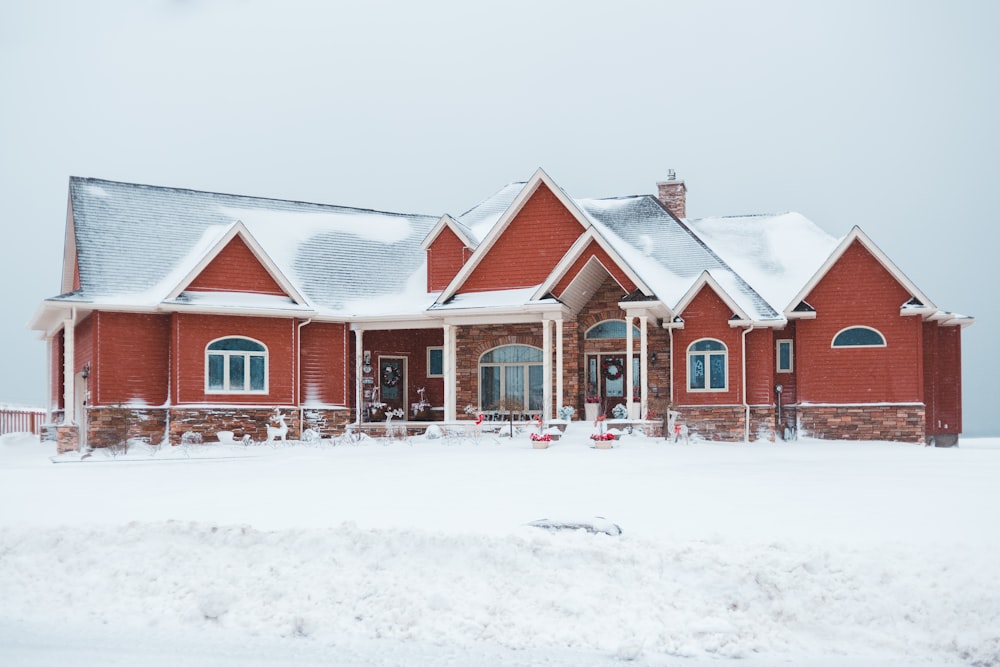 red and gray house during snow