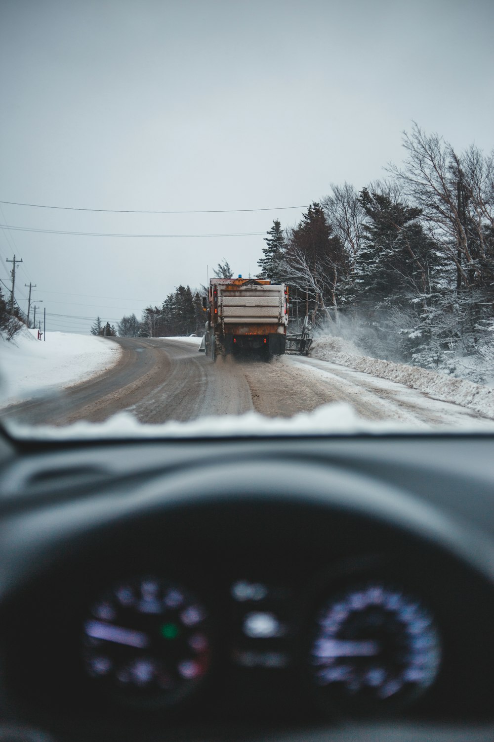 person on road behind gray truck during daytime