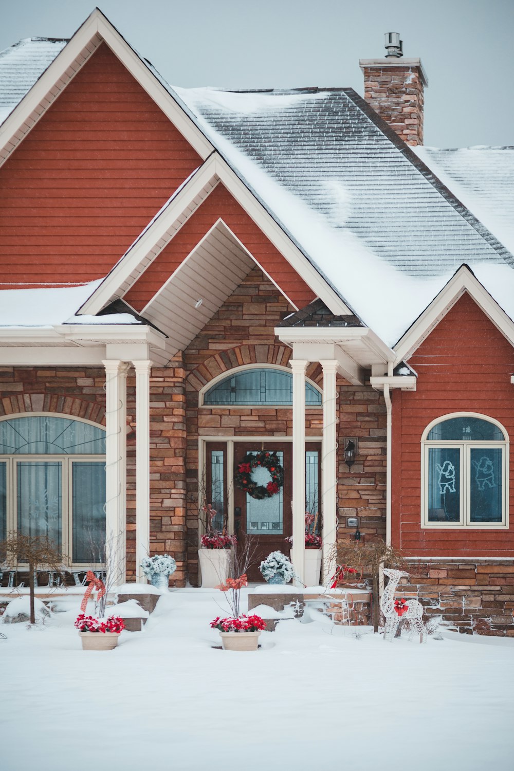 brown and white house with snowy ground