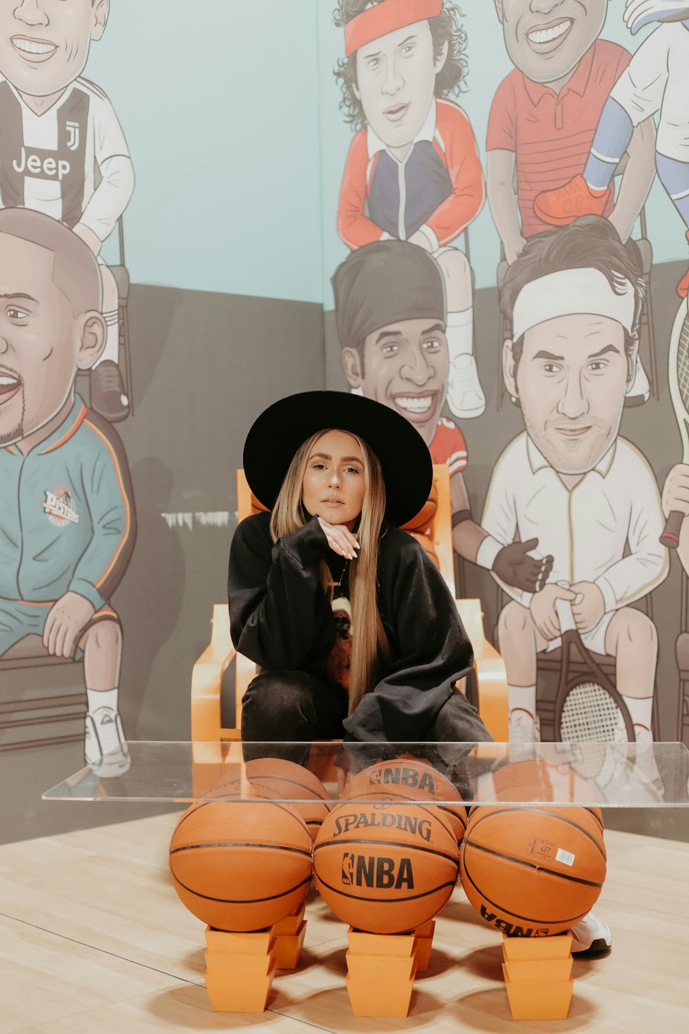 woman sitting beside basketball-themed coffee table