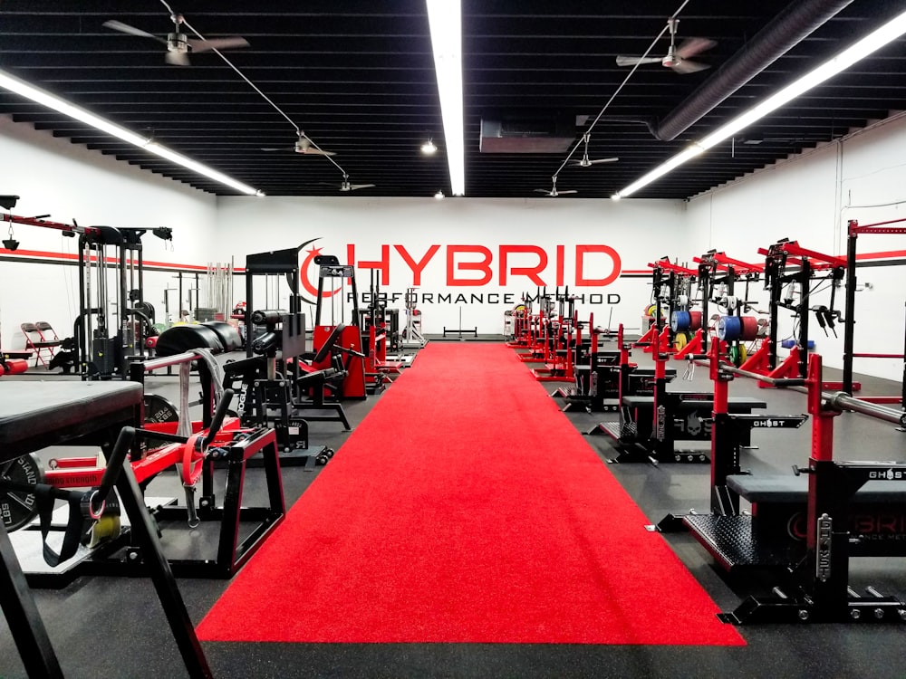 a gym with a red carpet and a red rug