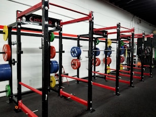 three red barbell machines