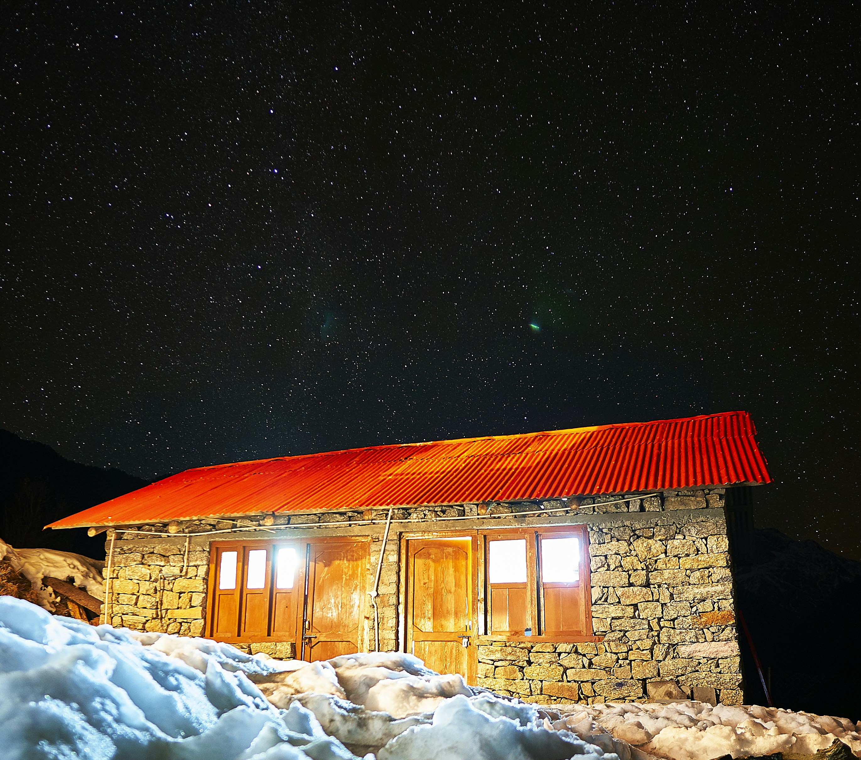stone house on snowfield during night