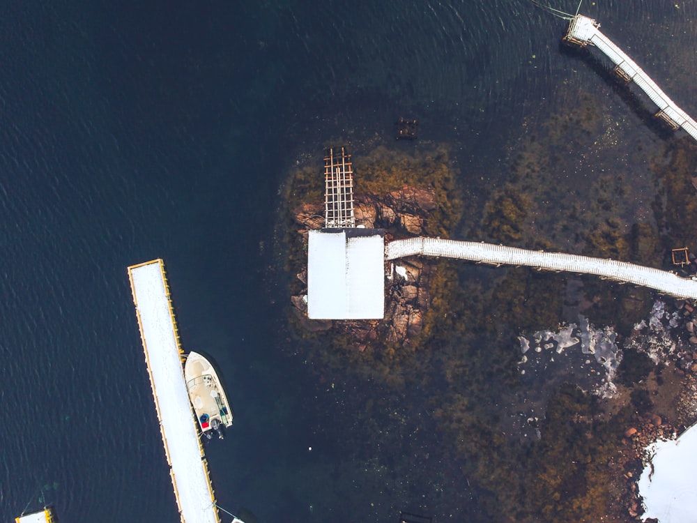 boat docked beside dock during day