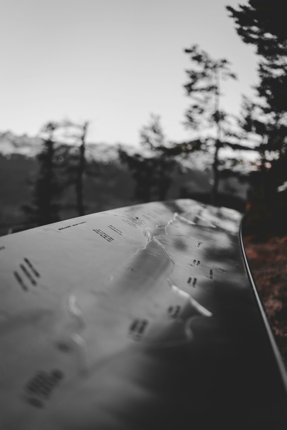 a close up of a windshield with trees in the background