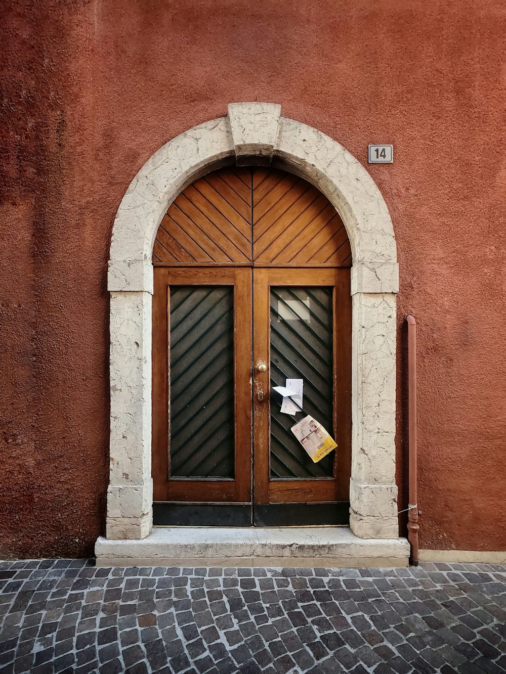 brown concrete building showing closed brown and gray wooden door