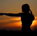 woman punching the air during golden hour