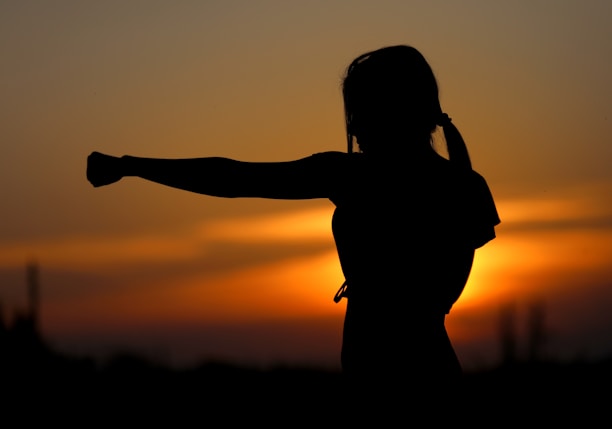 woman punching the air during golden hour