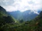 A scenic view of a taxi winding through lush green hills near Badrinath.