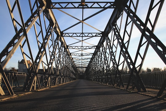 brown steel bridge under white and blue sky in Gironde France