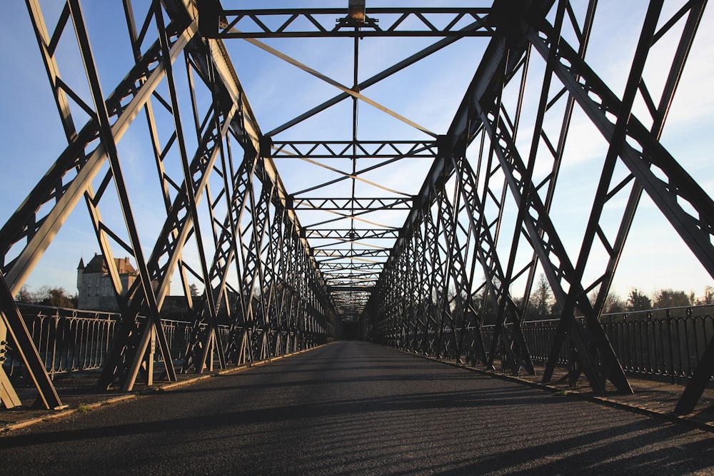 brown steel bridge under white and blue sky