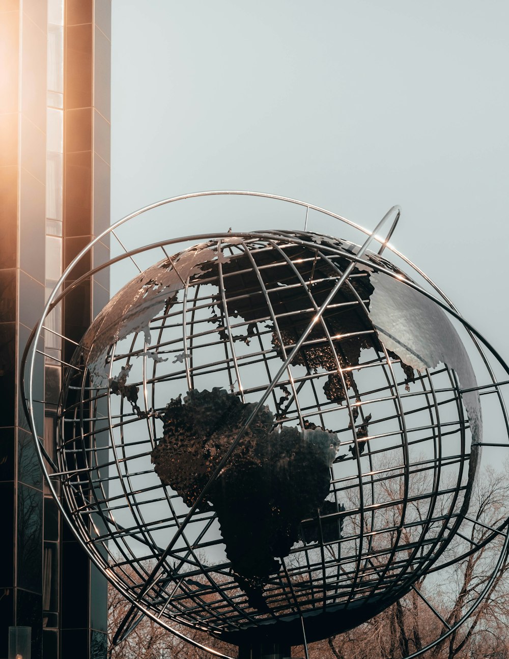 gray sphere statue near building